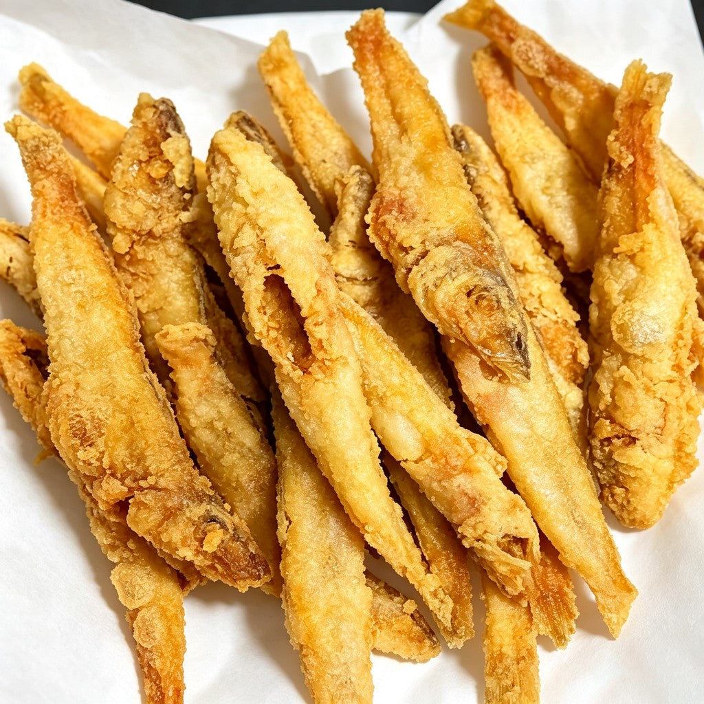 Deep-fried golden sillago fish on a white plate